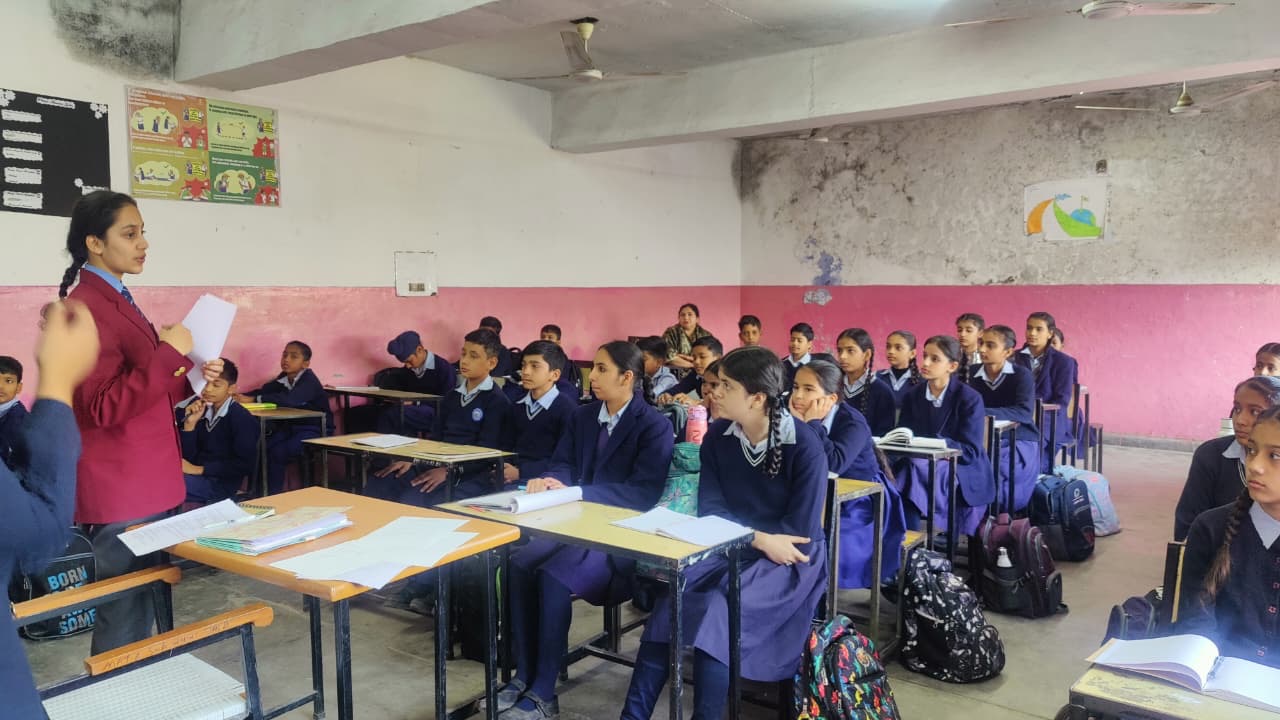 Volunteer running a classroom session with students