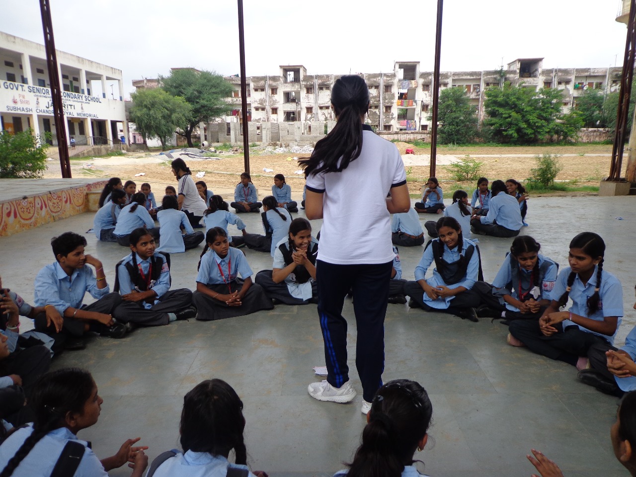Outdoor peer support session with students seated in a circle